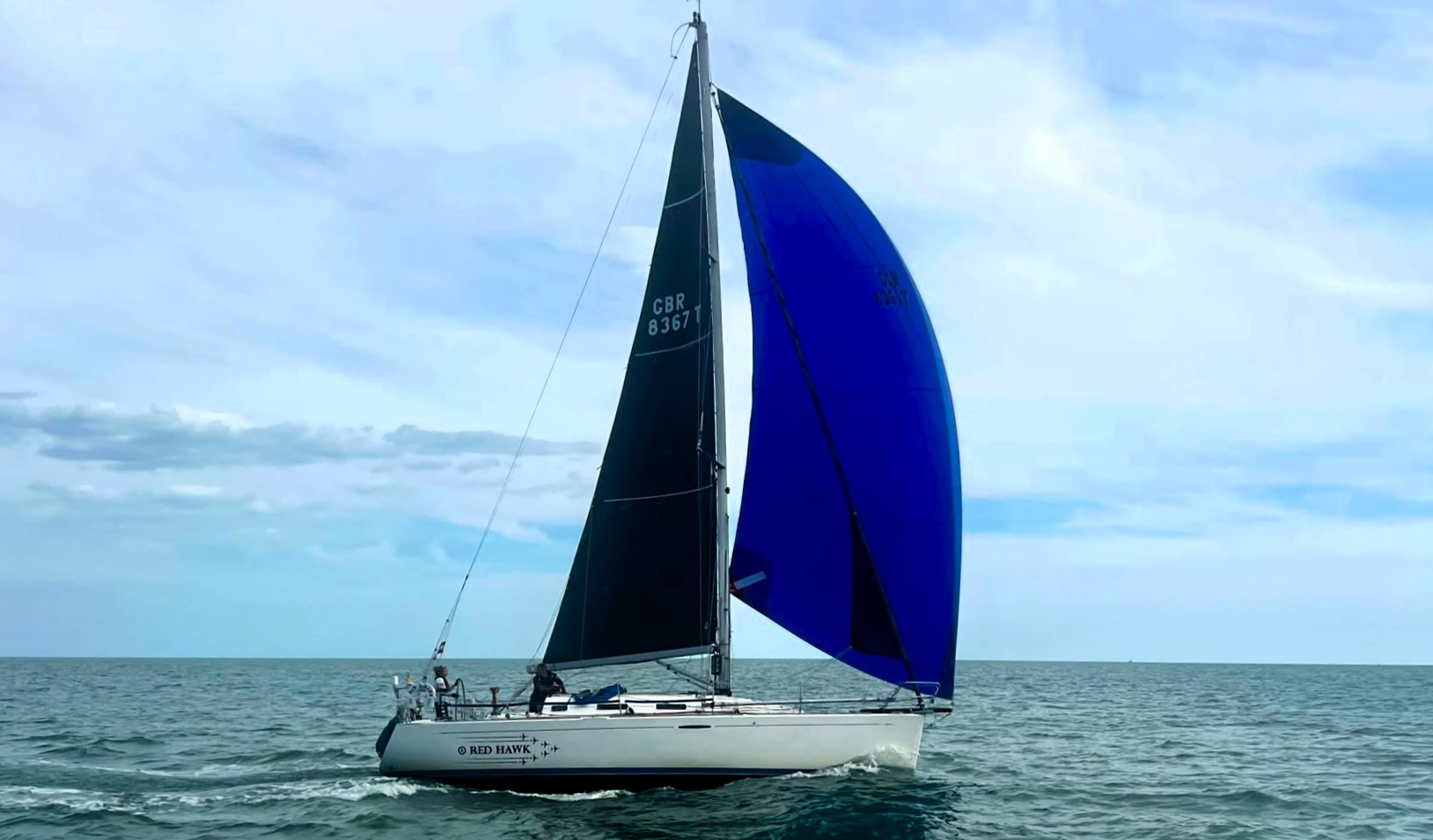 Your Yacht Name racing under spinnaker